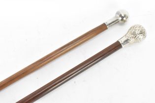 Two mid 20th century silver topped walking sticks, one having a ball knopped finial, hallmarked