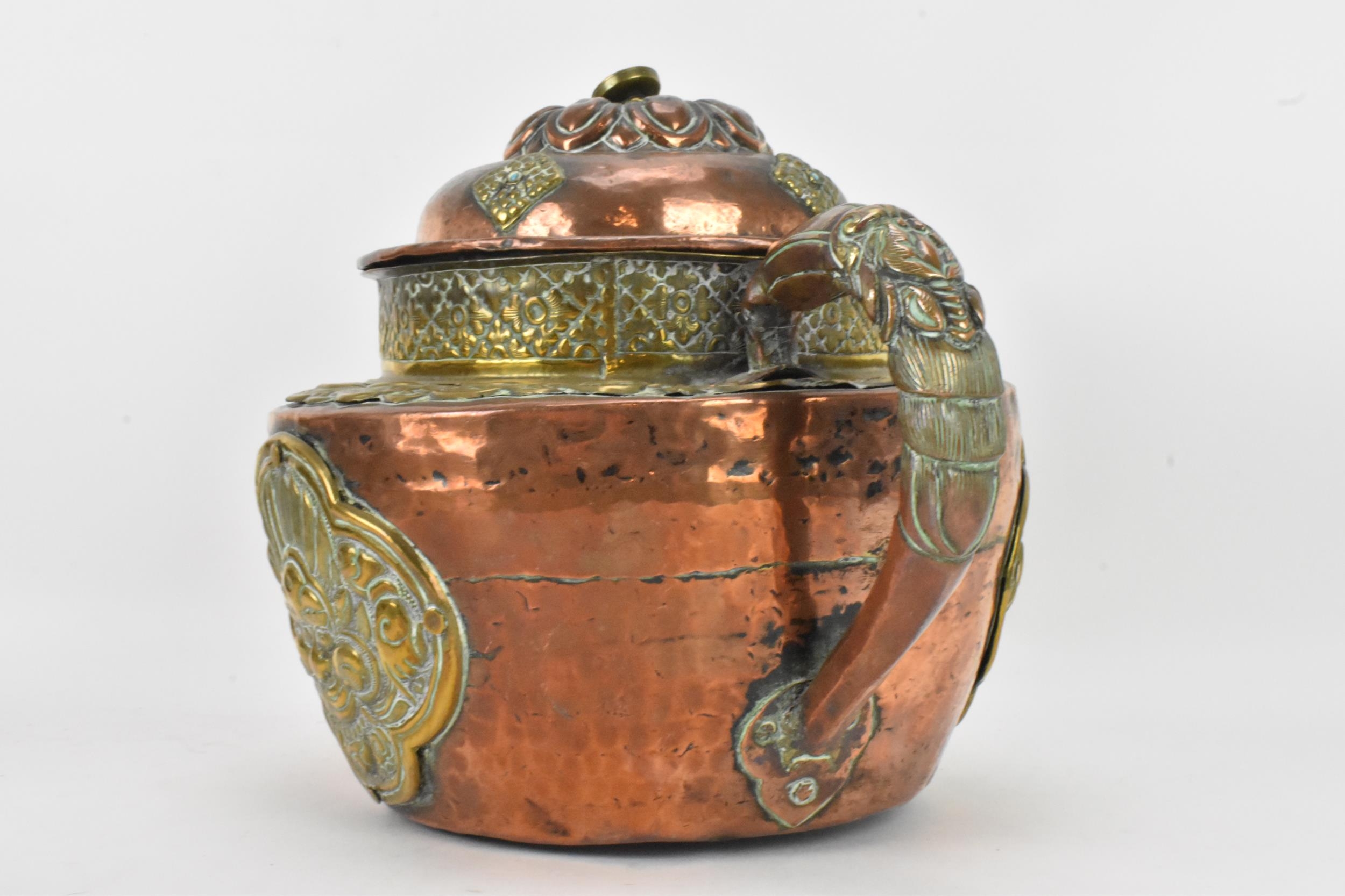 A 19th century Tibetan brass and copper large teapot, having an elephant formed spout, applied - Image 4 of 7