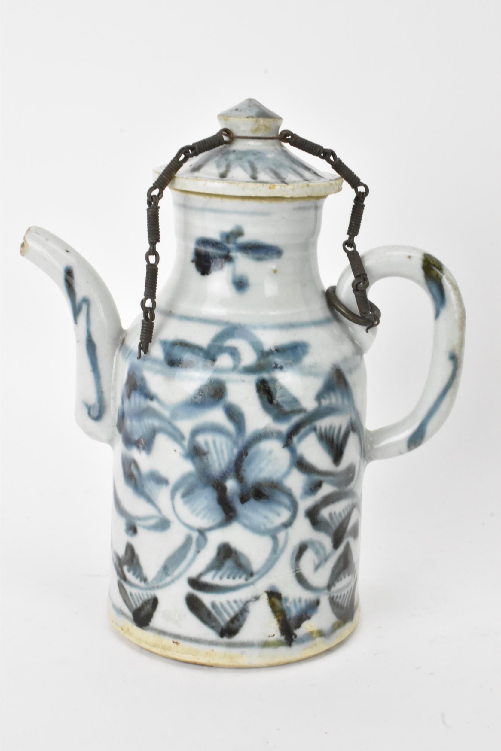 A Chinese ewer, late Ming dynasty, decorated in underglaze blue with flowers, loop shaped handle and - Image 3 of 7