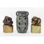 Two Chinese soapstone seals carved with animals raised on oval formed bases carved with landscape