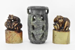 Two Chinese soapstone seals carved with animals raised on oval formed bases carved with landscape