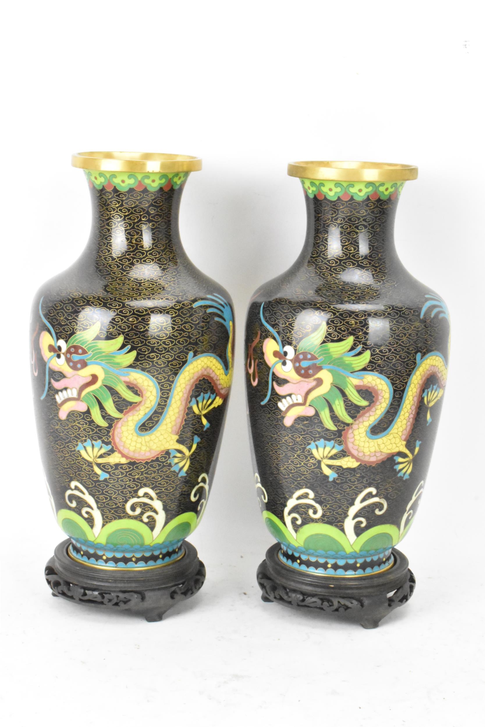 A pair of Chinese mid 20th century cloisonne vases and a bowl, all with black grounds decorated with - Image 4 of 12