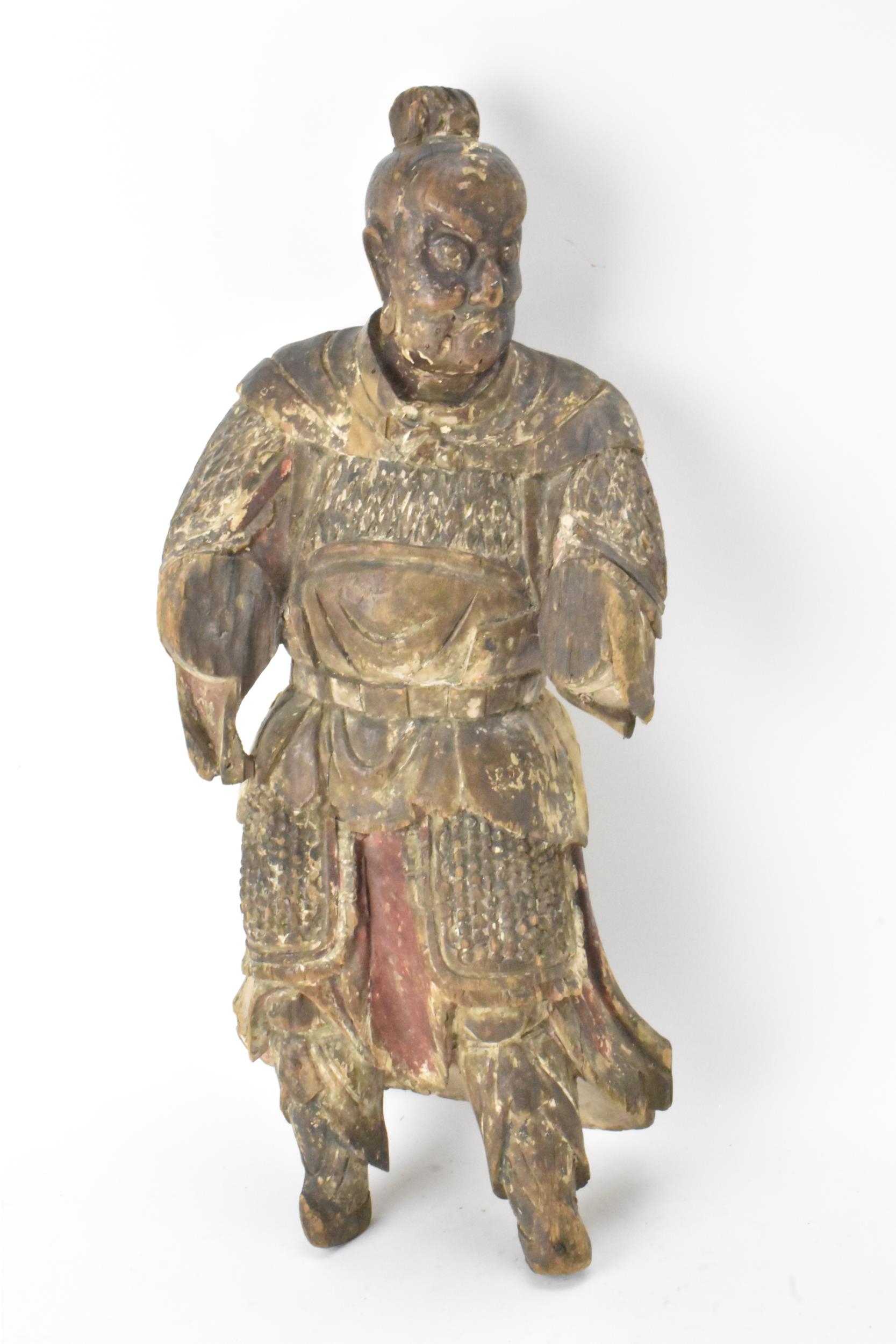 A Chinese carved and painted wood figure of a warrior, late Ming/Qing dynasty, in traditional