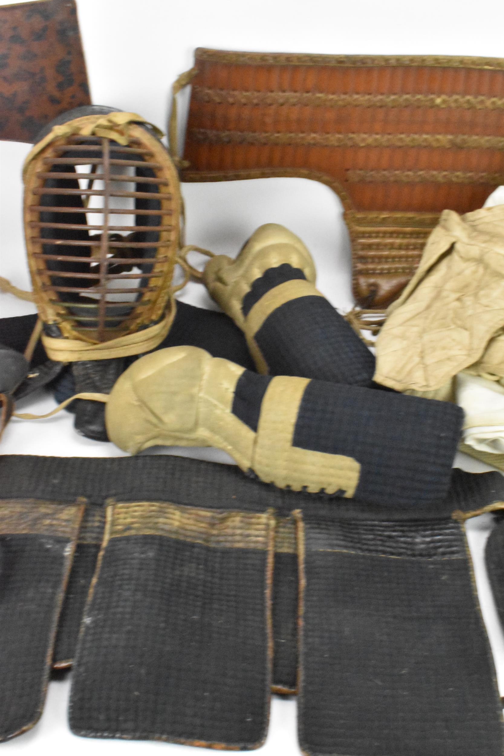 A Japanese Kendo uniform/suit of armour, comprising a helmet, knee pads, belts, jackets, hakama - Image 3 of 12