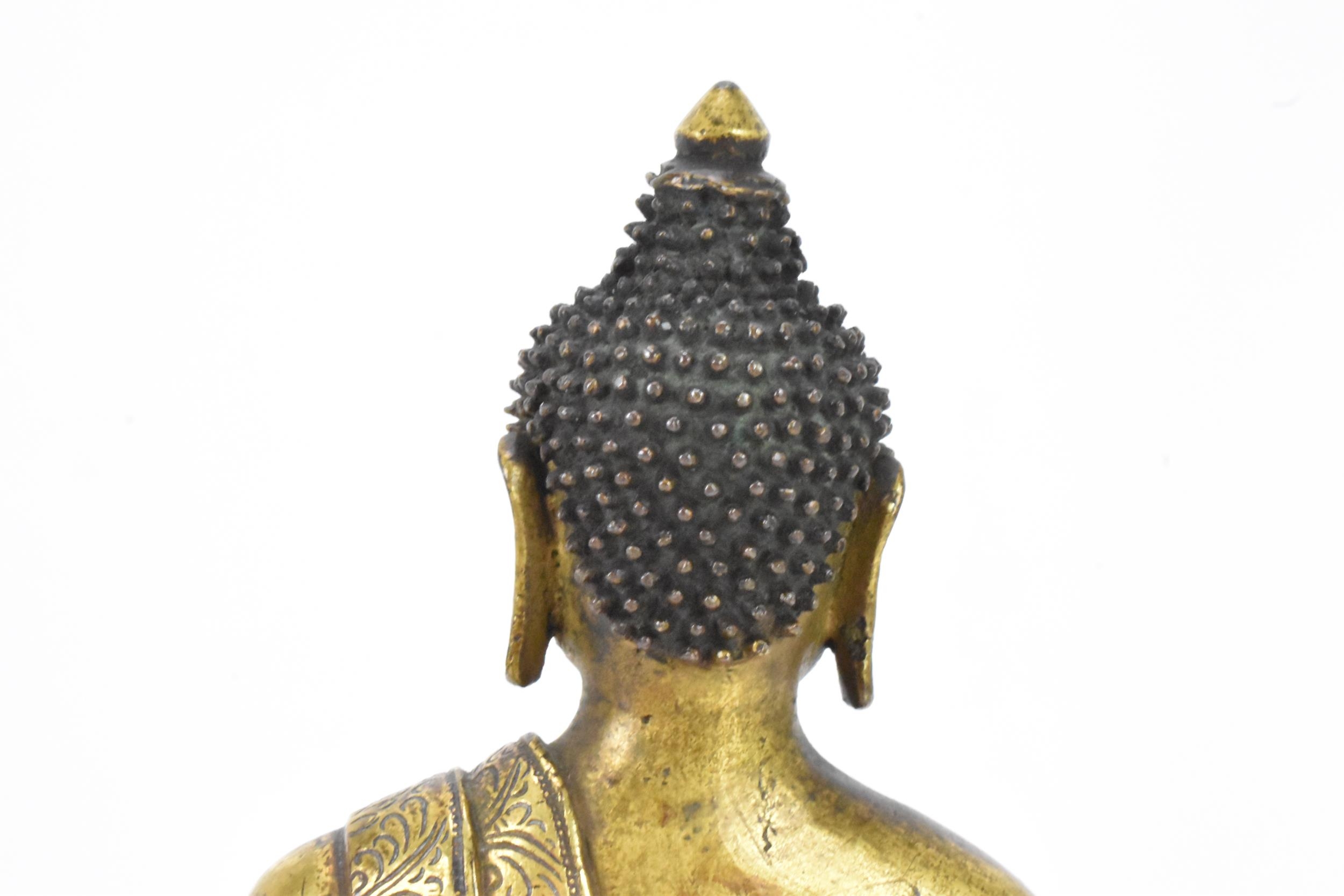 A Sino Tibetian gilt bronze figure of Buddha, 18th/19th century, dressed in monastic robe, with - Image 10 of 16