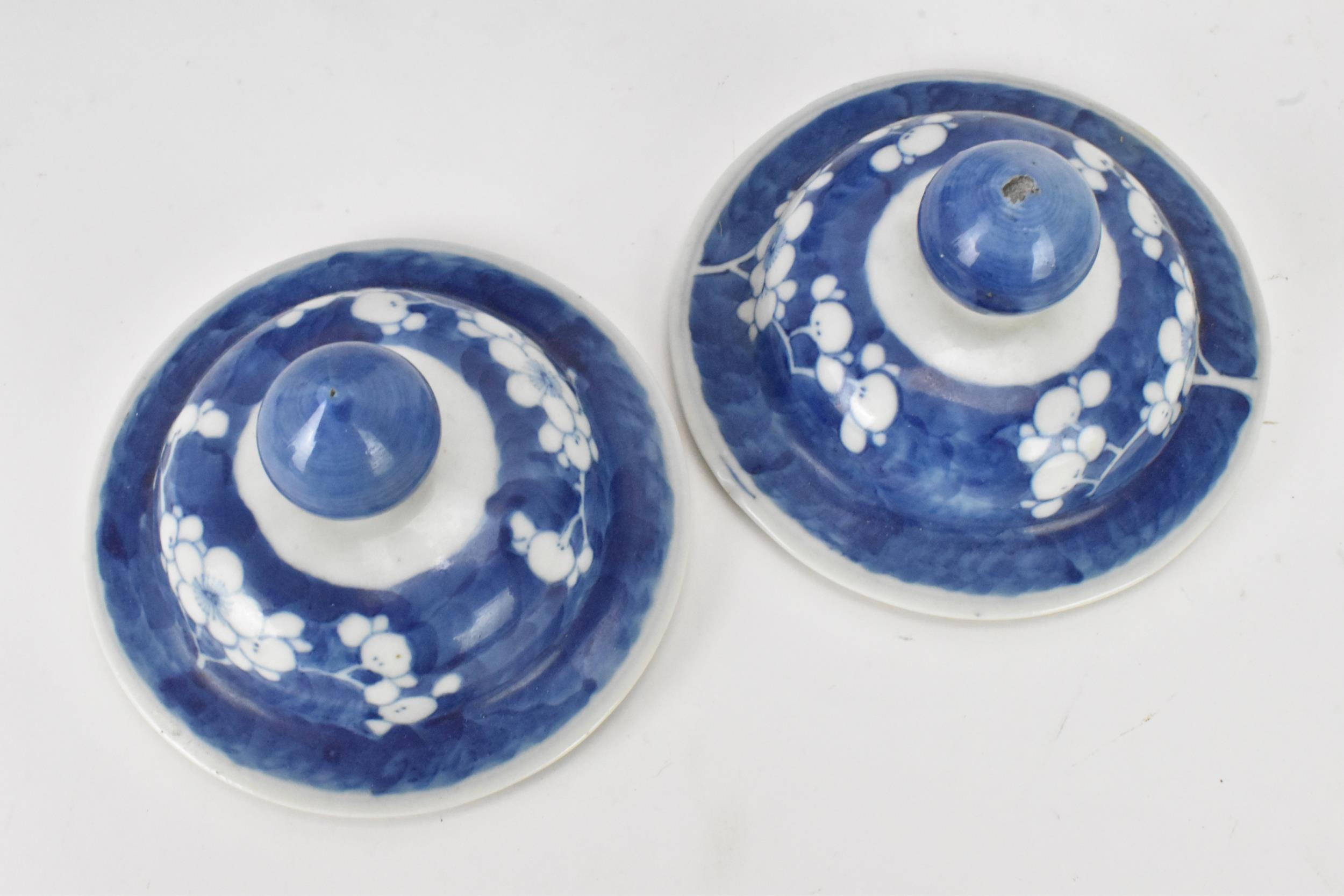 A pair of Chinese prunus pattern blue and white vases, late Qing Dynasty, both of baluster form with - Image 5 of 8