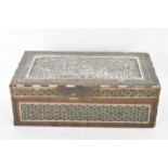 A late 19th century Indo-Persian cigarette box, decorated with a silver repousse panel to the lid