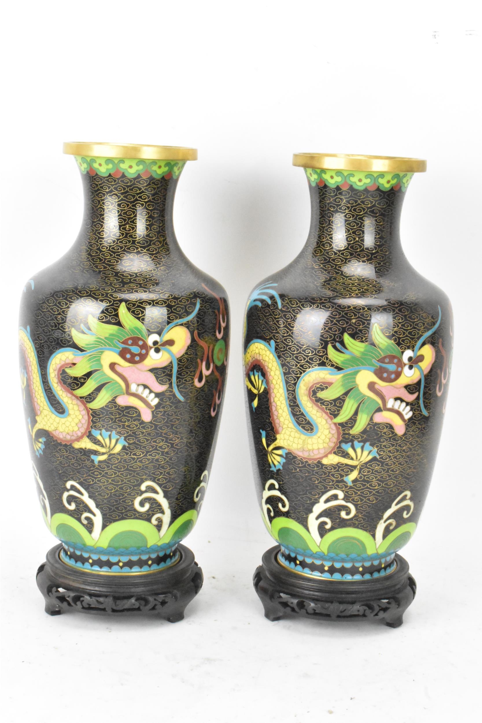 A pair of Chinese mid 20th century cloisonne vases and a bowl, all with black grounds decorated with - Image 2 of 12