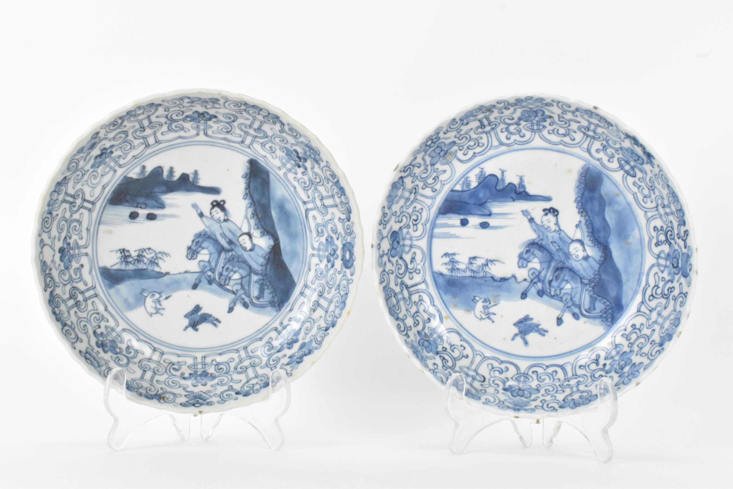 A pair of Qing Dynasty blue and white dishes, with fluted sides and barbed rim, decorated on the - Image 2 of 9