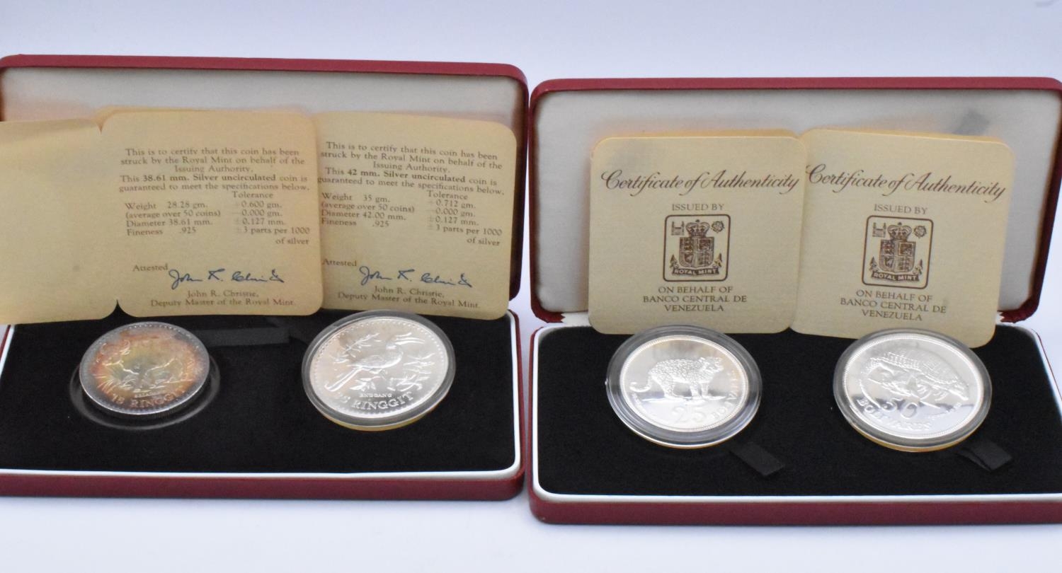 Royal Mint - A pair of cased Two-Coin Silver commemoratives to include Venezuela 50 and 25