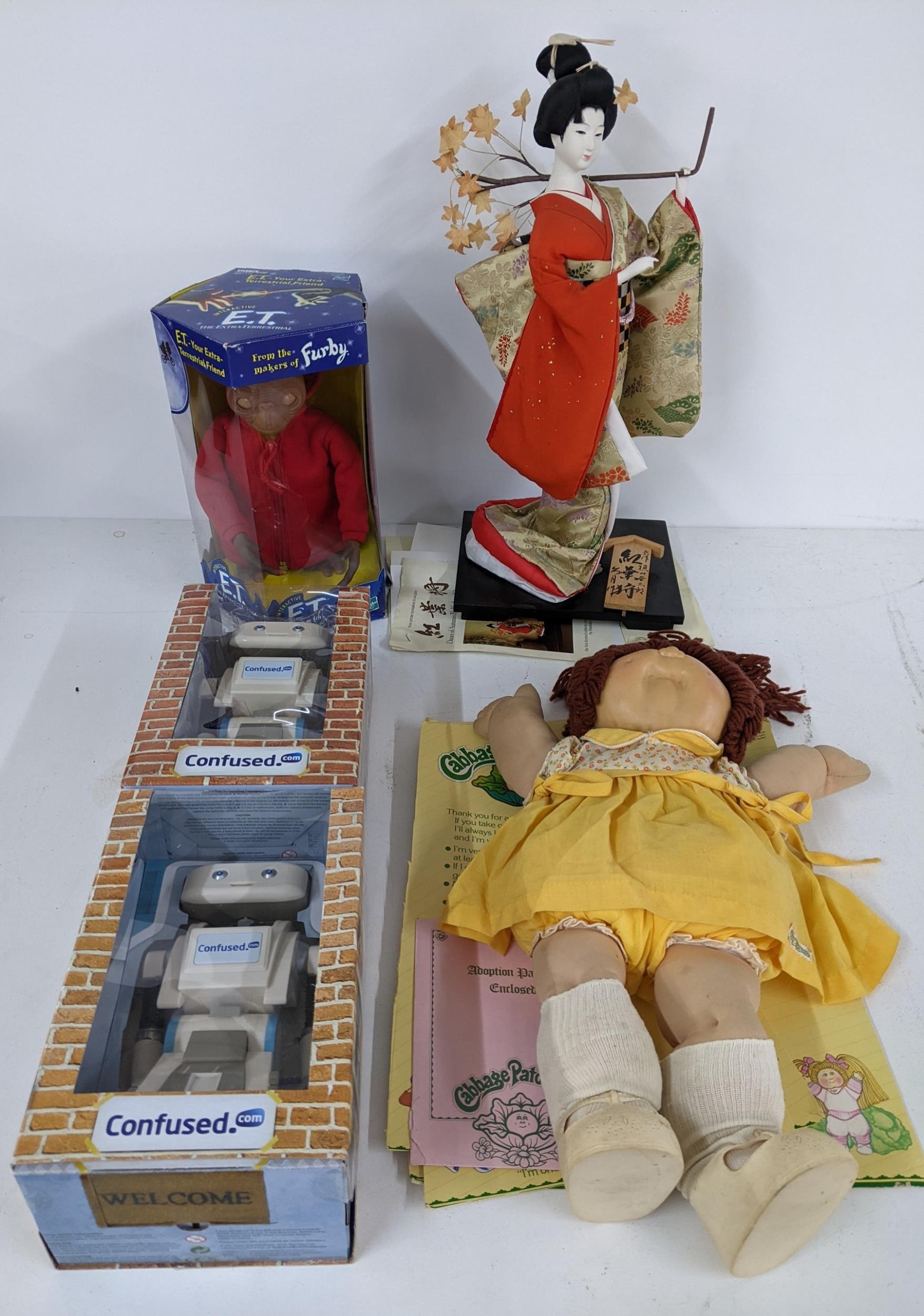 A mixed lot of figurines to include an interactive E.T, a Cabbage Patch Kid with adoption paperwork,