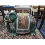 A 20th century conservatory stool fashioned as an elephant draped in Indian textiles and finery