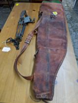 A leather gun case slip and a Sideboatham gamekeepers gin trap, Catalogue note:- the gin tray is