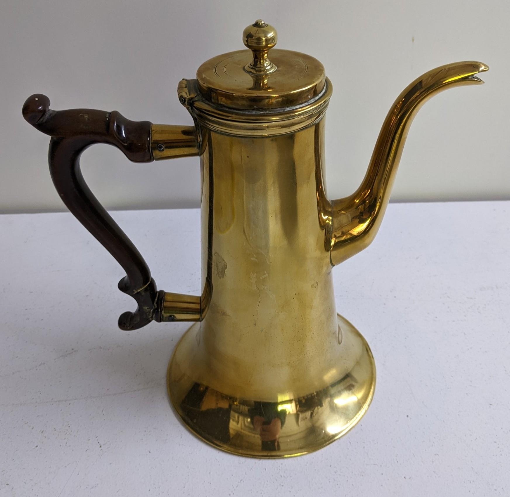 A 19th century brass coffee pot with turned timber handle Location: