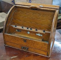 A late Victorian oak table top letter/stationery cabinet having a tambour roll top, fitted
