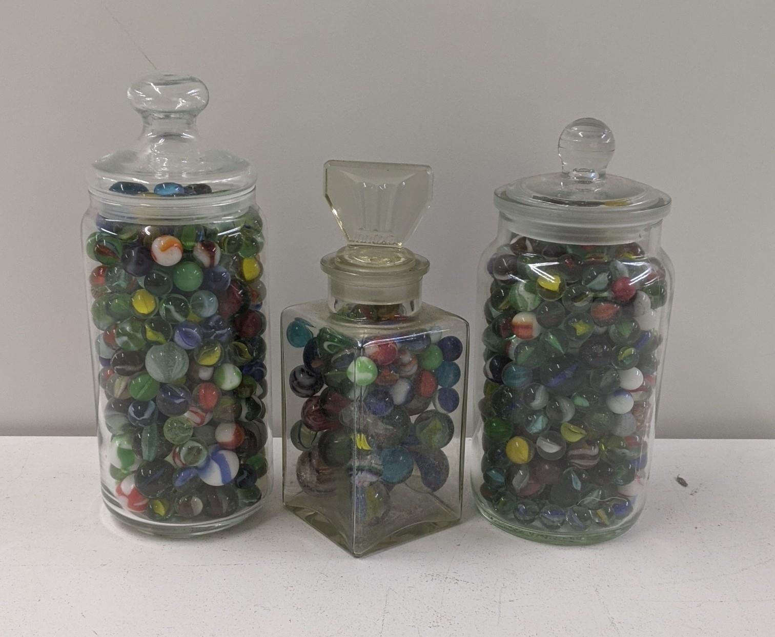 A variety of Victorian and later marbles, housed in three glass jars Location: If there is no