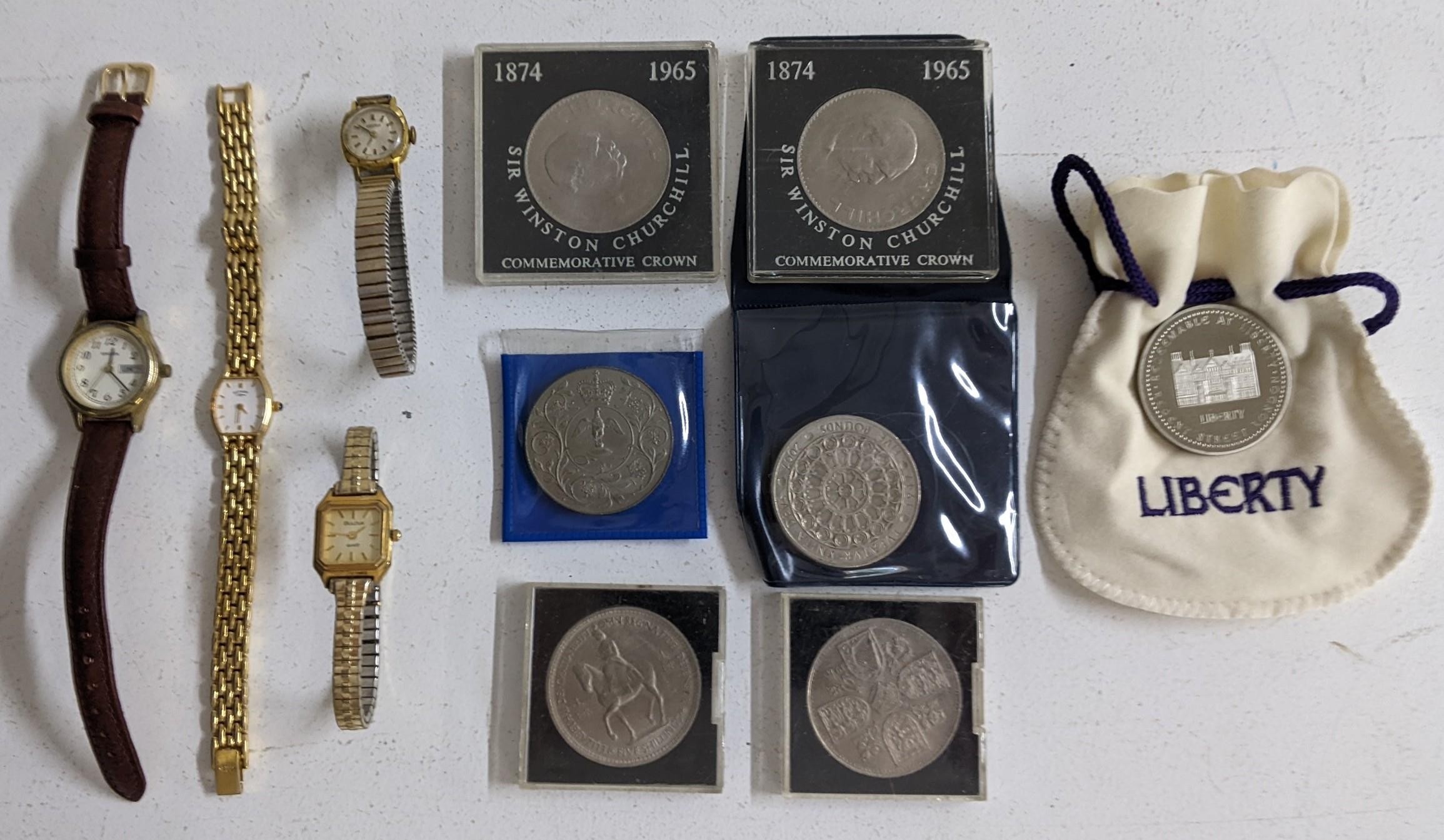 A mixed lot of coins and ladies wristwatches to include a liberty £25 coin various commemorative £