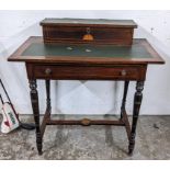 An Edwardian walnut writing desk having a storage compartment above a green leather top and drawer