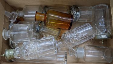 A collection of small glass dressing table bottles and jars, most of them with stoppers Location: