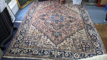 A Persian handwoven rug having a central motif and geometric designs 333cm x 250cm Location: If