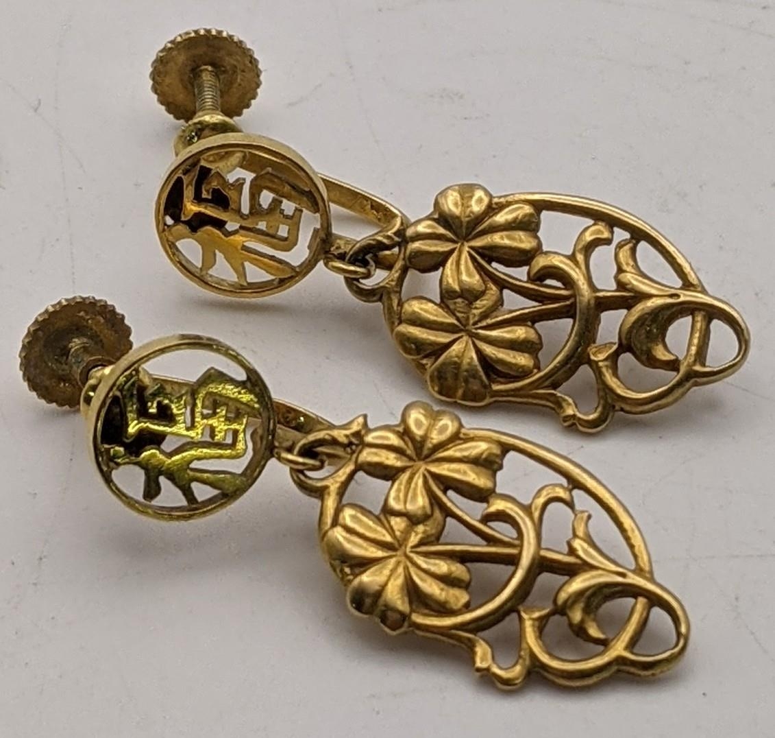 A pair of 14ct gold earrings having a floral pierced design Location:CAB5