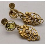 A pair of 14ct gold earrings having a floral pierced design Location:CAB5