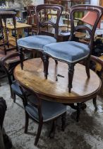 A mahogany oval breakfast table on four splayed legs together with a four bar back dining chair