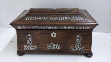 A William IV rosewood sarcophagus formed box, inset with mother of pearl and standing on bun