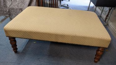 A modern beige upholstered foot stool on turned legs 38cm h x 102.5cm w Location: If there is no