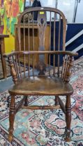 A Victorian elm and ash Windsor armchair with a hooped back, turned spindles and central splat
