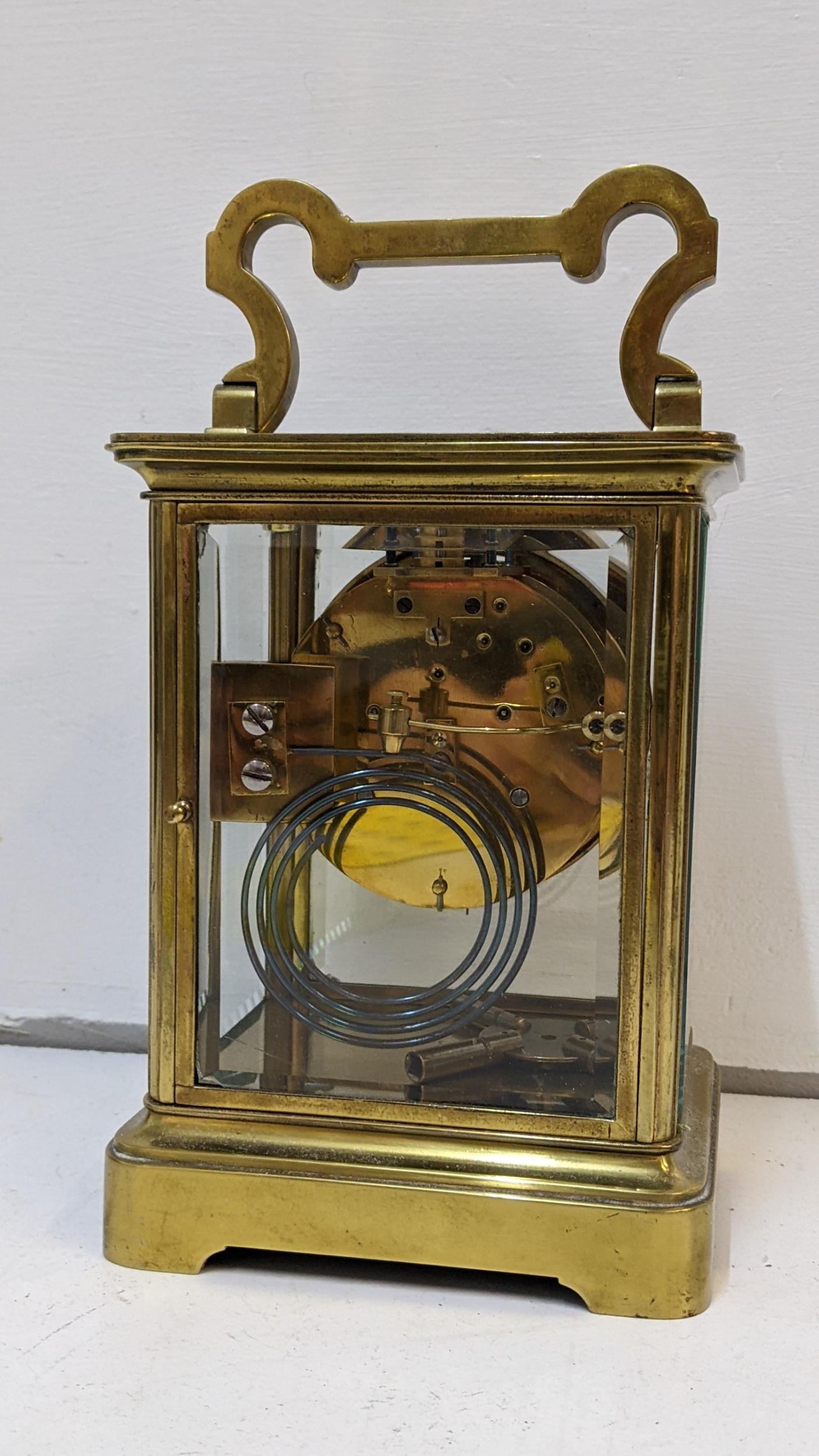 A large early 20th century brass cased carriage style clock with a painted dial and gong strike - Image 3 of 3