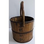 A Chinese wooden and metal band rice bucket Location: If there is no condition report shown please