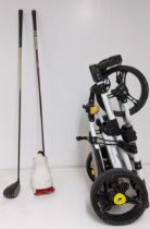 An Aldila voodoo hi-launch golf driver, a Yonex Stiff driver, together with an I Cart-Uno golf