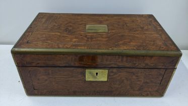 A 19th century writing slope having a coromandel interior, blue leather scriber with brass mounts,