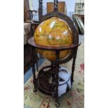 A vintage globe drinks cabinet, having a hinged top opening to reveal a fitted interior, 96cm h x