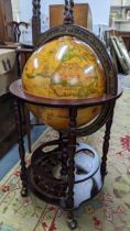 A vintage globe drinks cabinet, having a hinged top opening to reveal a fitted interior, 96cm h x