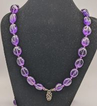 An amethyst coloured beaded necklace with a silver clasp inset with diamante paste stones Location:
