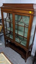 An Edwardian mahogany two door display cabinet with an open shelf below, 168cm h x 106cm w Location: