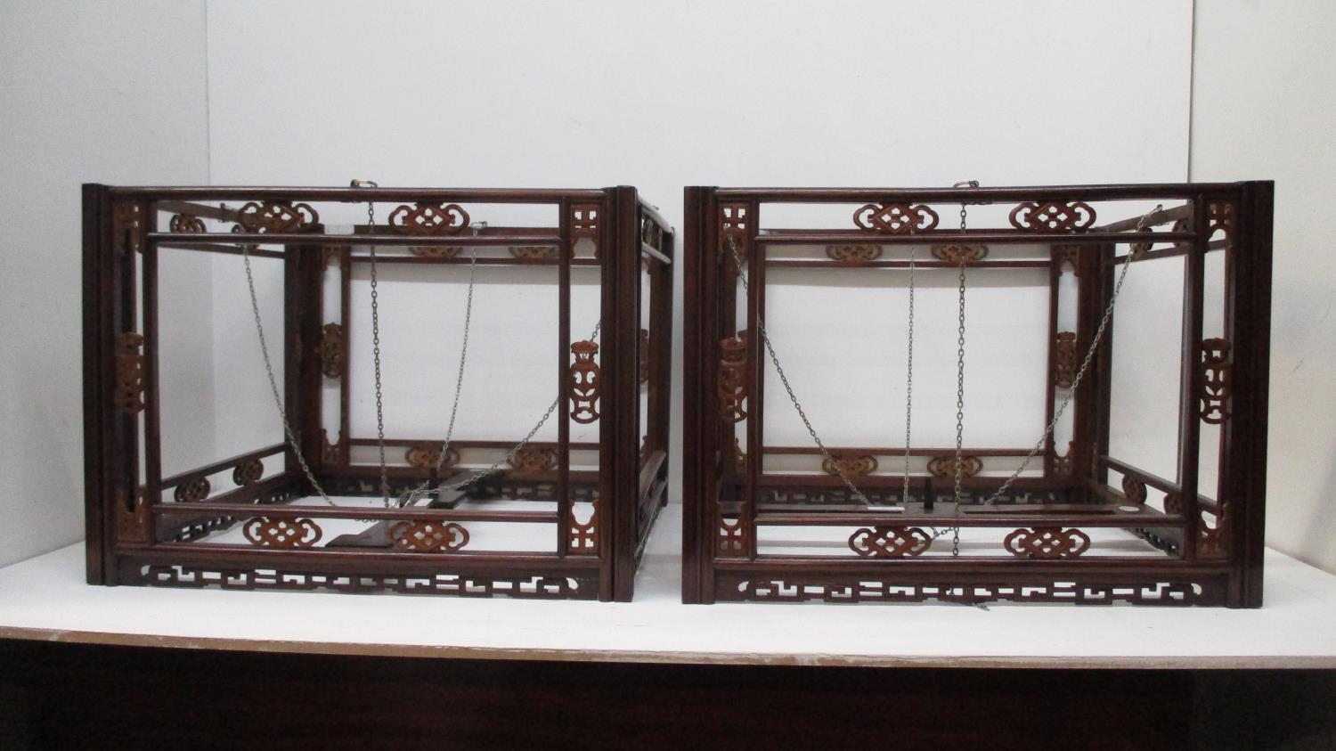 A pair of 19th century Chinese tielimu and boxwood hanging lanterns, carved and fretworked with