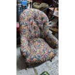 A late Victorian button back upholstered armchair, floral leaf decoration, turned mahogany front