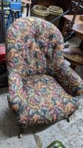 A late Victorian button back upholstered armchair, floral leaf decoration, turned mahogany front