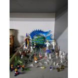 A collection of glass hemwork animals and figurines to include a monkey and a dog, horse and rider
