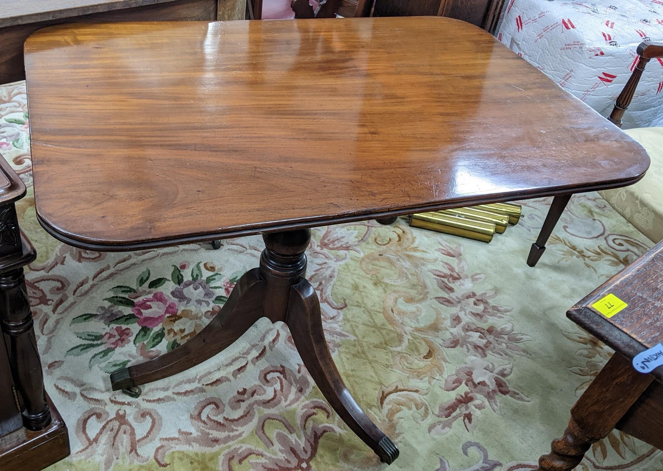 An early 20th century Regency style mahogany occasional table having a turned column and three