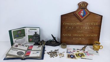 A mixed lot to include a naval plaque, naval related badges and cufflinks, brass model of a canon