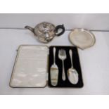 A boxed silver plated desert set to include a silver plated teapot on a plated stand with ornate