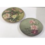 A pair of Victorian earthenware pottery chargers decorated with flowers, signed C Chambers to the