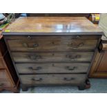 A George III mahogany chest of four graduated long drawers with a brushing slide, on bracket feet
