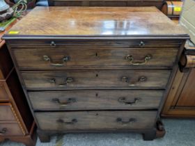A George III mahogany chest of four graduated long drawers with a brushing slide, on bracket feet