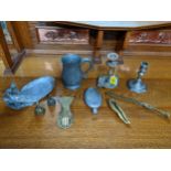 A selection of metalware to include a brass paper knife, miniature lady tea bells, paper clip in the