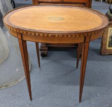 A late 19th/early 20th century satinwood oval topped occasional table having parquetry inlaid and on
